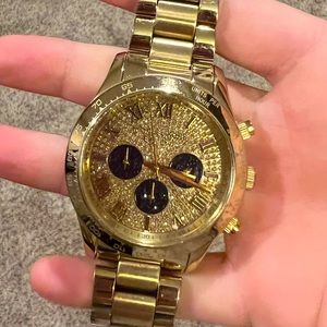 Michael Kors gold watch W/ black and white crystals on the face. Good condition